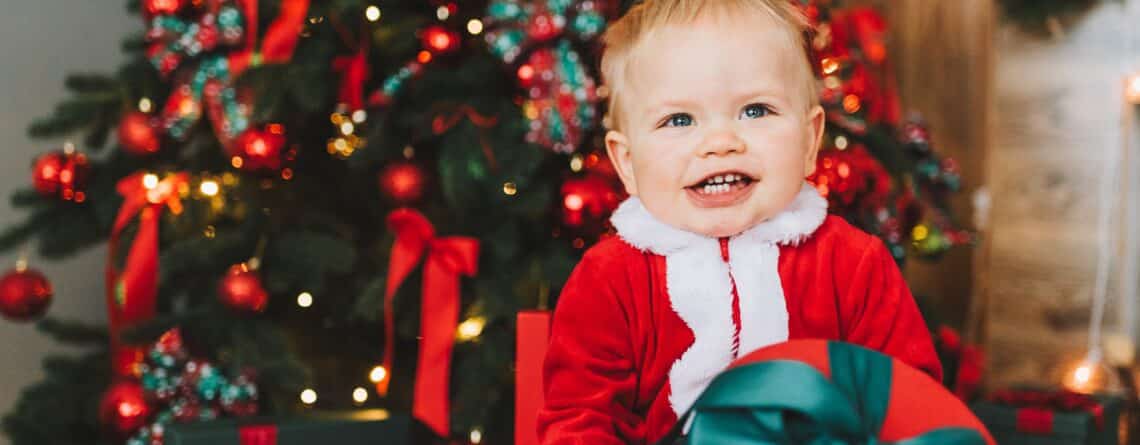 Kid in front of Christmas tree