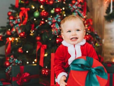 Kid in front of Christmas tree