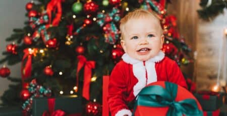 Kid in front of Christmas tree